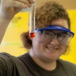 student looking at chemistry tube