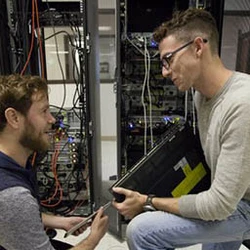 Student working on computer server rack