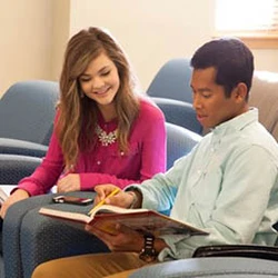 Two students reading book